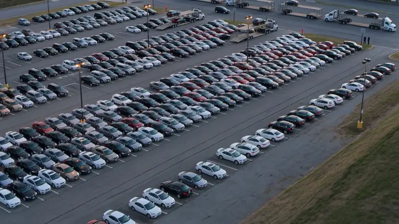 Aerial view of an auto auction lot with car-hauler trucks